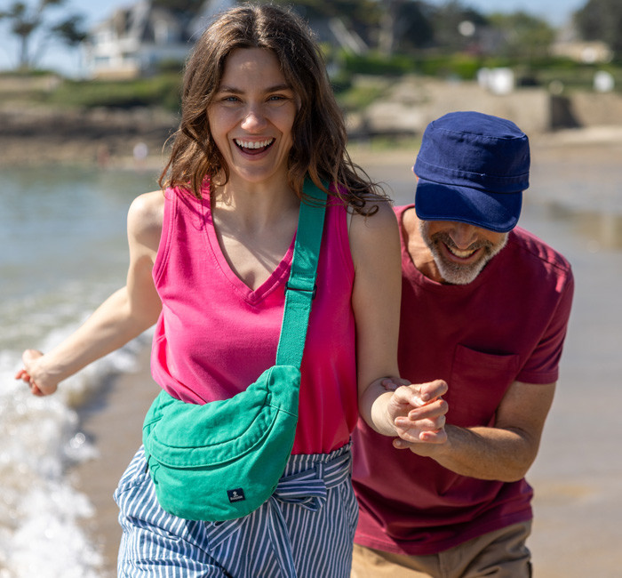 Man wearing a blue shirt with fish print and woman wearing a yellow striped blouse
