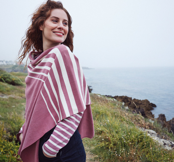 Femme portant un poncho rayé rose et blanc