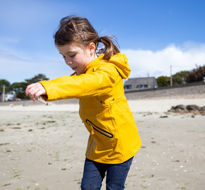Child wearing a yellow raincoat